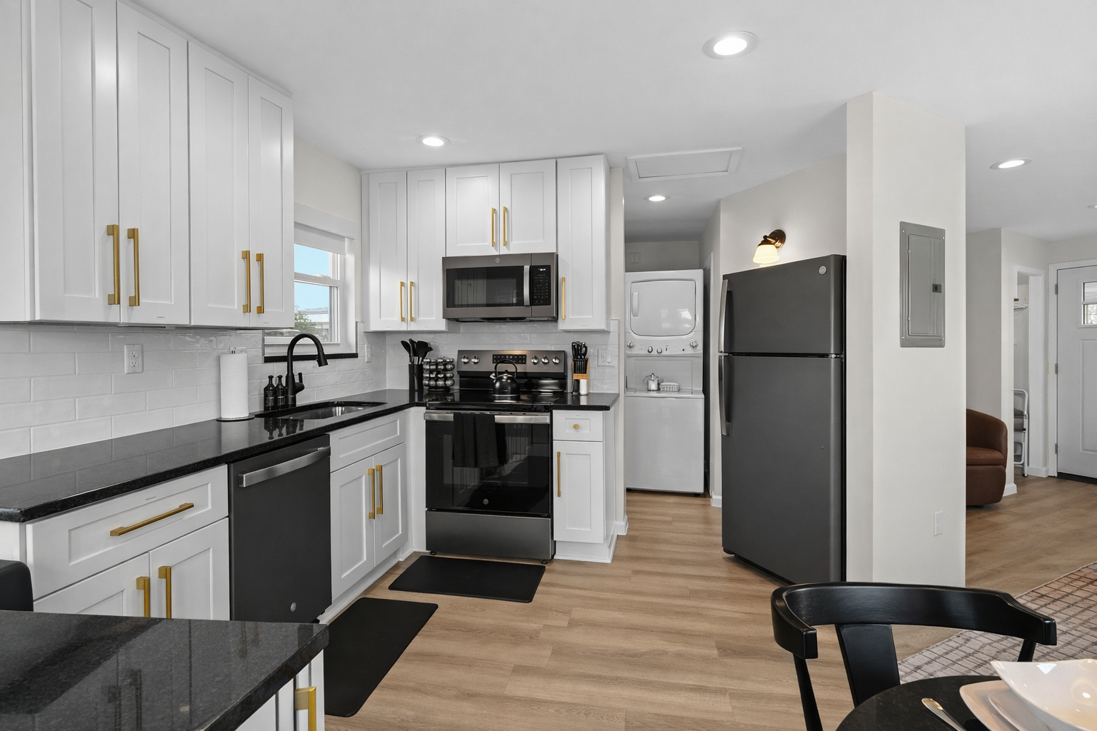 Spacious, modern kitchen with full-size appliances, ample storage, and in-unit laundry—bright, functional, and designed for easy, comfortable stays.