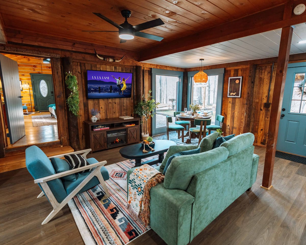 Cinema nights meets woodland vibes in our open-concept 600 sq. ft. living suite