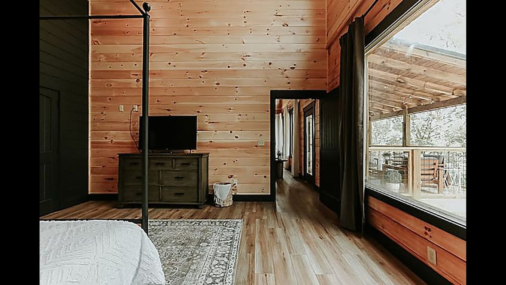 Wake up to soft morning light and peaceful forest views from this cozy, sunlit bedroom