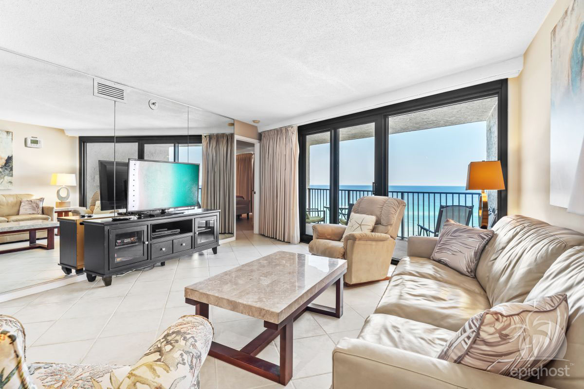 Open living area with coastal furnishings and emerald gulf views