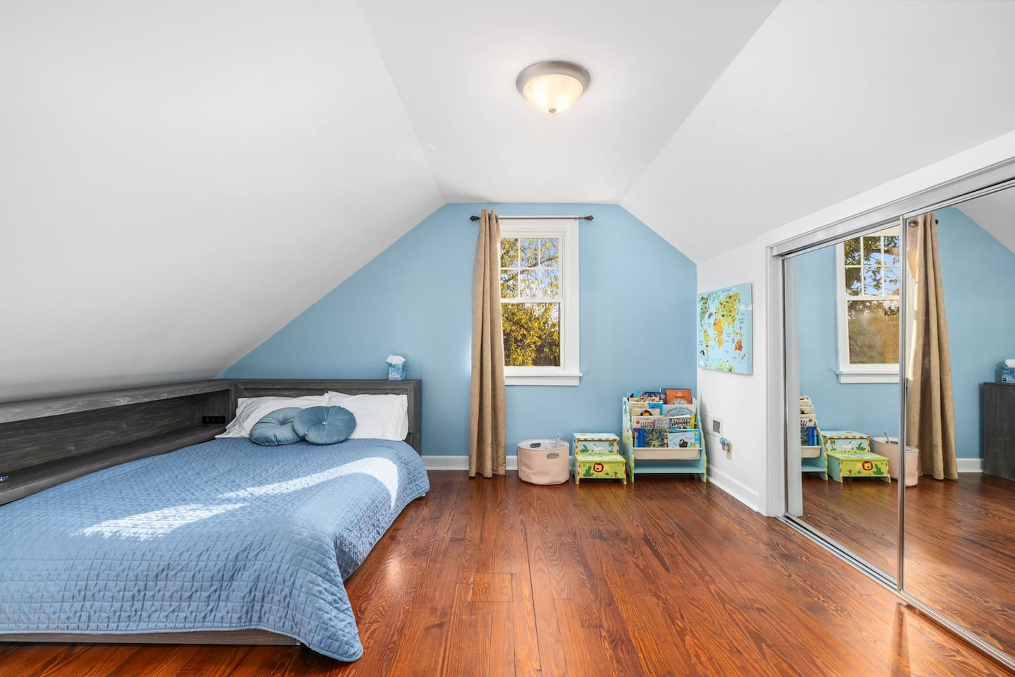 Upstairs bedroom 3, Full size bed with built in USB charging station and power outlet. Space includes children's books and a few toys for the kids .  Cozy reading chair, black out curtain, closet storage.