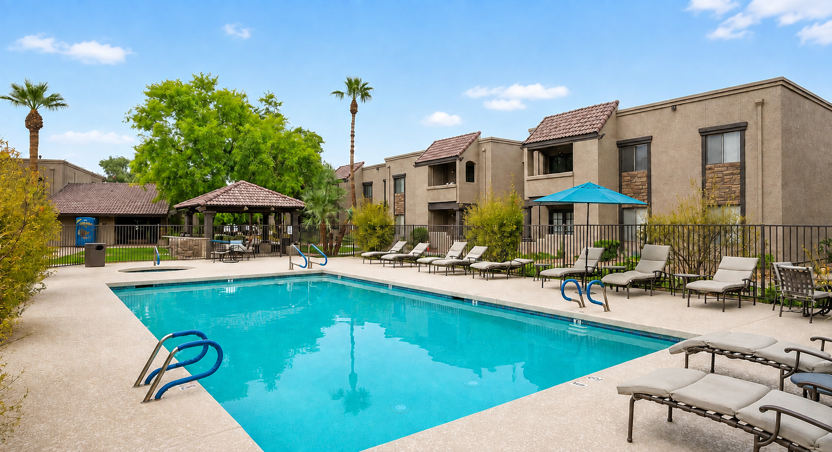 Shared community pool and spa area with lounge seating, sunny patio space, and room to unwind outdoors.