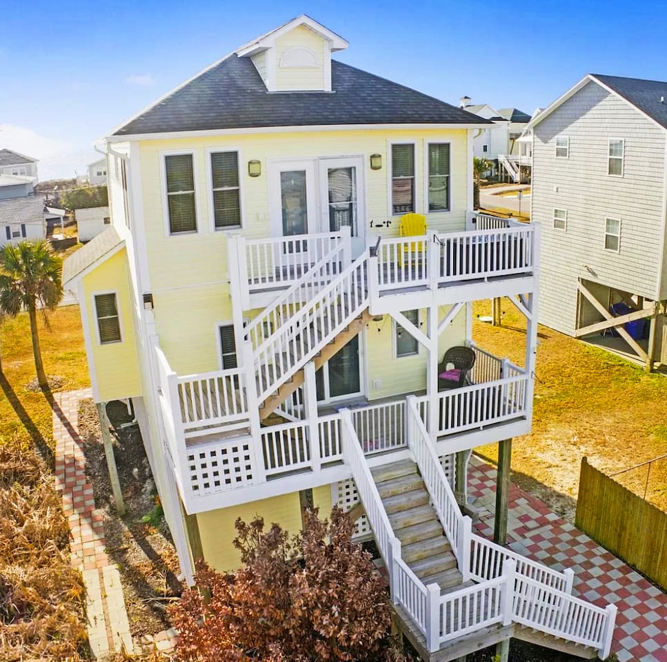 Balconies galores! Steps to access master bedroom downstairs to kitchen/living room upstairs. Pathway leads to the firepit and outdoor sitting area!