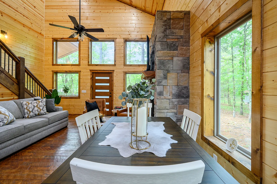 Cozy dining area overlooking the beautiful open living space and wooded surroundings