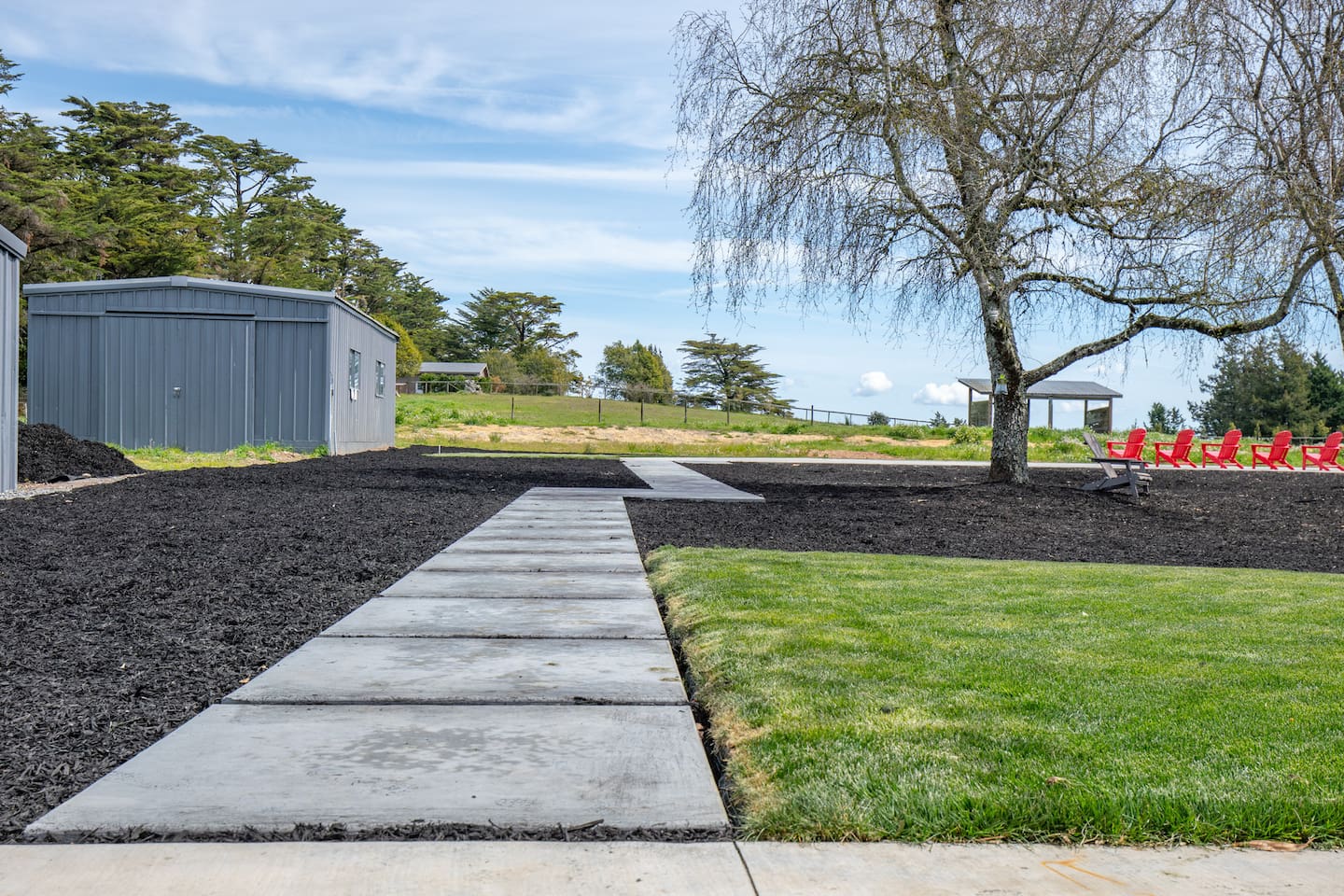 Vast outdoor grounds and a pathway guiding you to the inviting pool. 