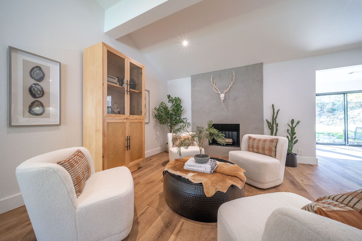 Stylish fireplace focal point with modern hearth design, curated décor, and comfortable lounge seating.