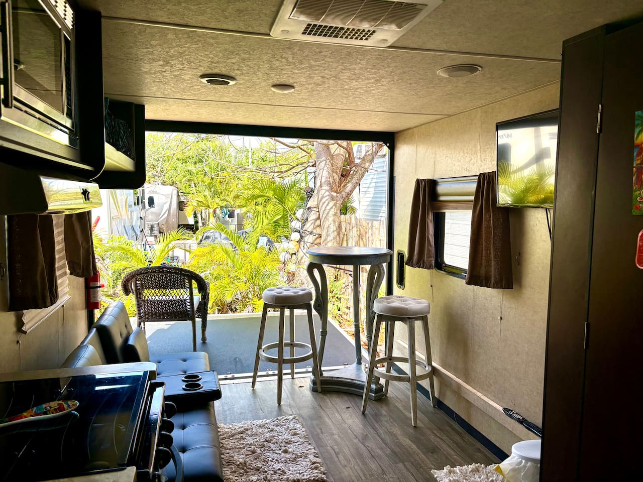Living area with wall dropped down. TV, table, couch.