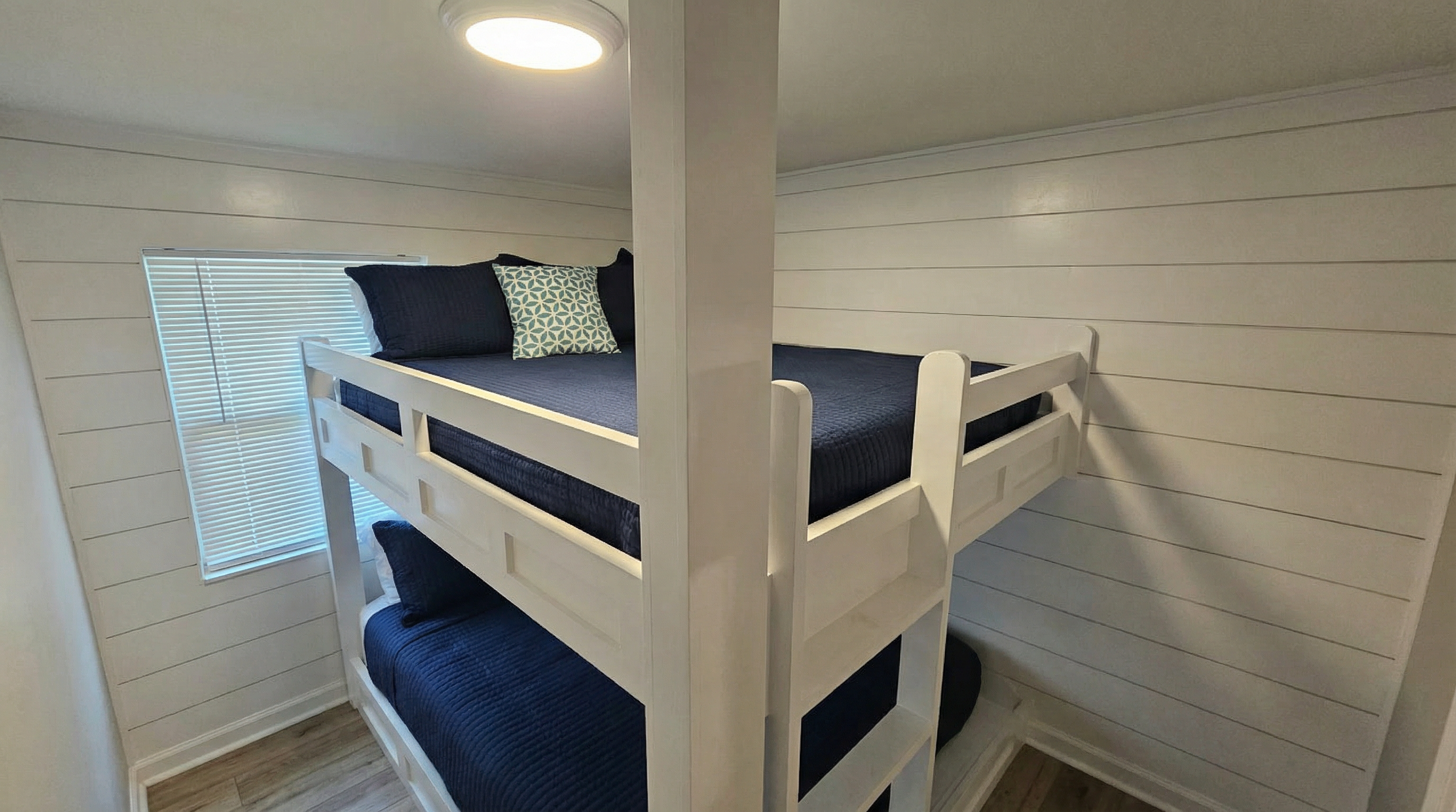 Built in - custom queen over queen bunks.  Each bunk has its own light and cubby to charge electronics