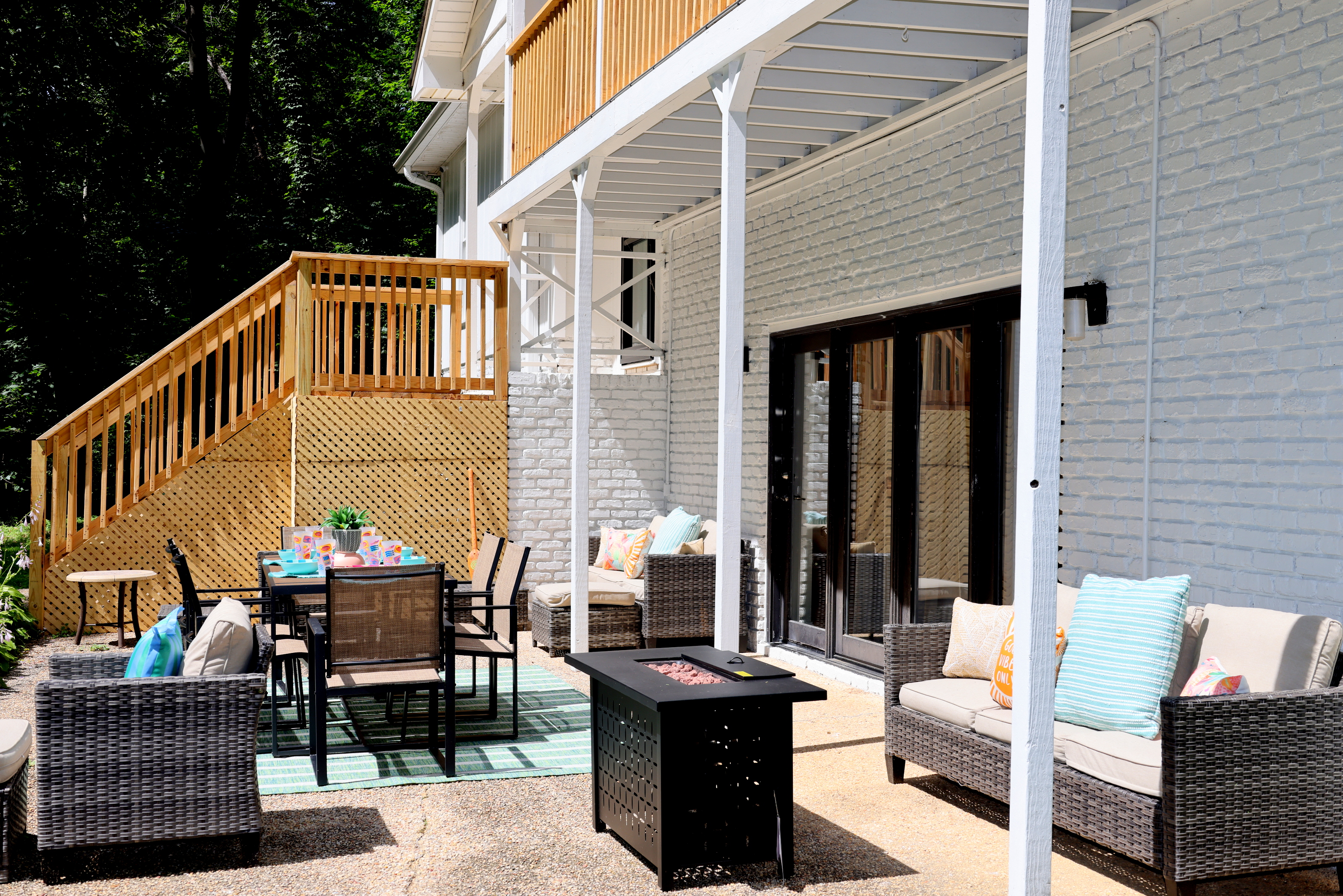 Relaxing outdoor patio with seating, dining space, and fire table for enjoying the lake house setting