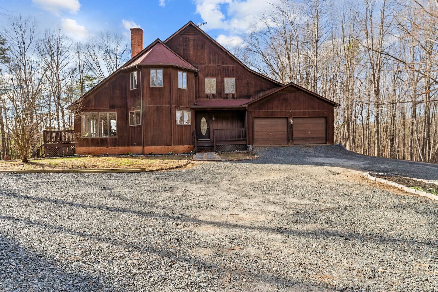 Exterior: Embrace nature with this stunning wooden retreat surrounded by serene wooded views!