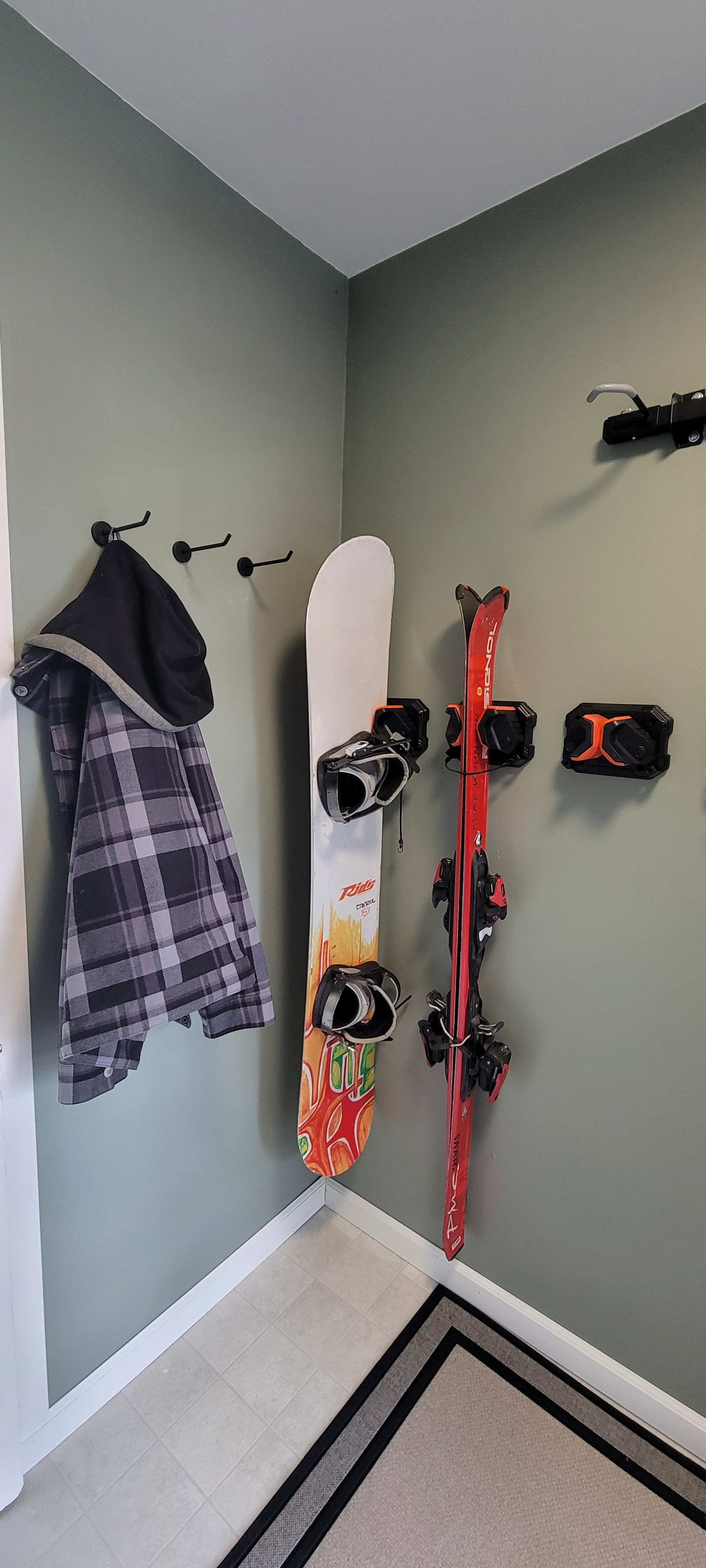 Ski and snowboard racks in mudroom plus large hooks for drying gear.