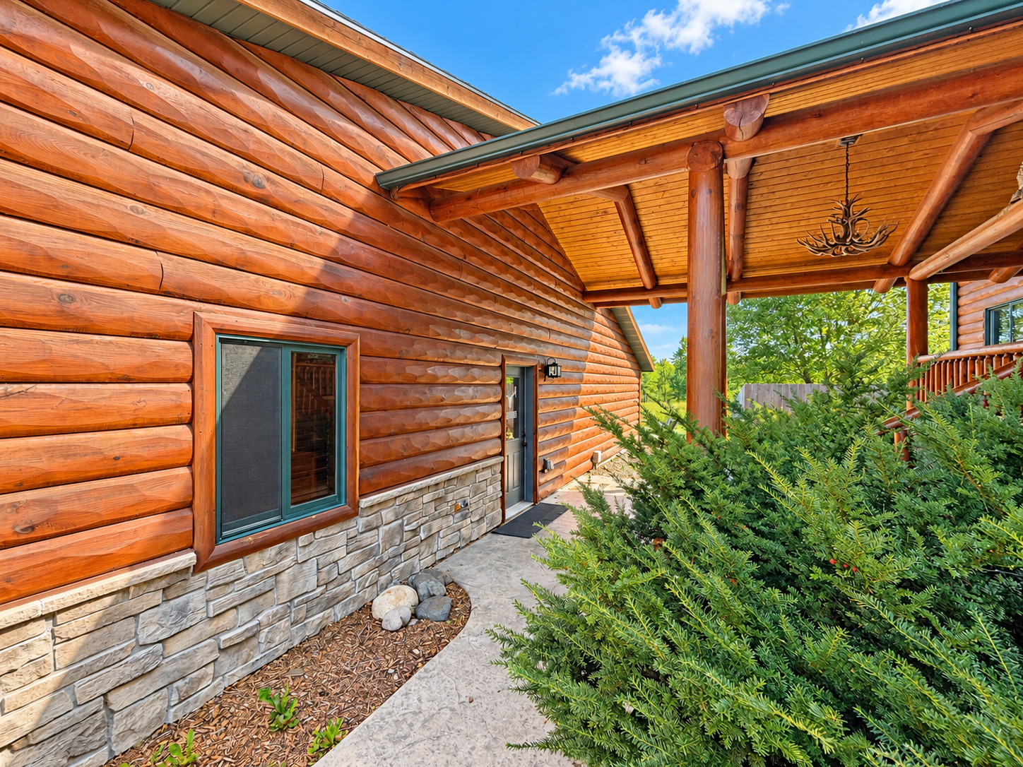 As you make your way in, Northwoods Antler Lodge sits to the left, offering an inviting first look at the property and its peaceful Northwoods setting.