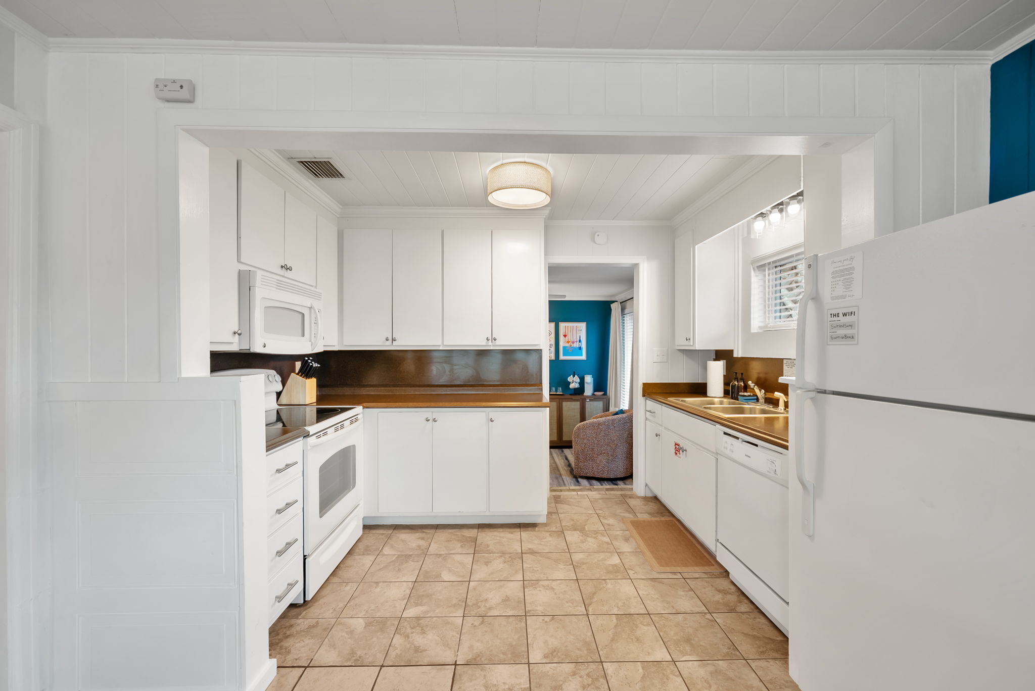 Full kitchen and  appliances wrapping two walls. Everything you
need to prep a Gulf-side dinner for 10.
