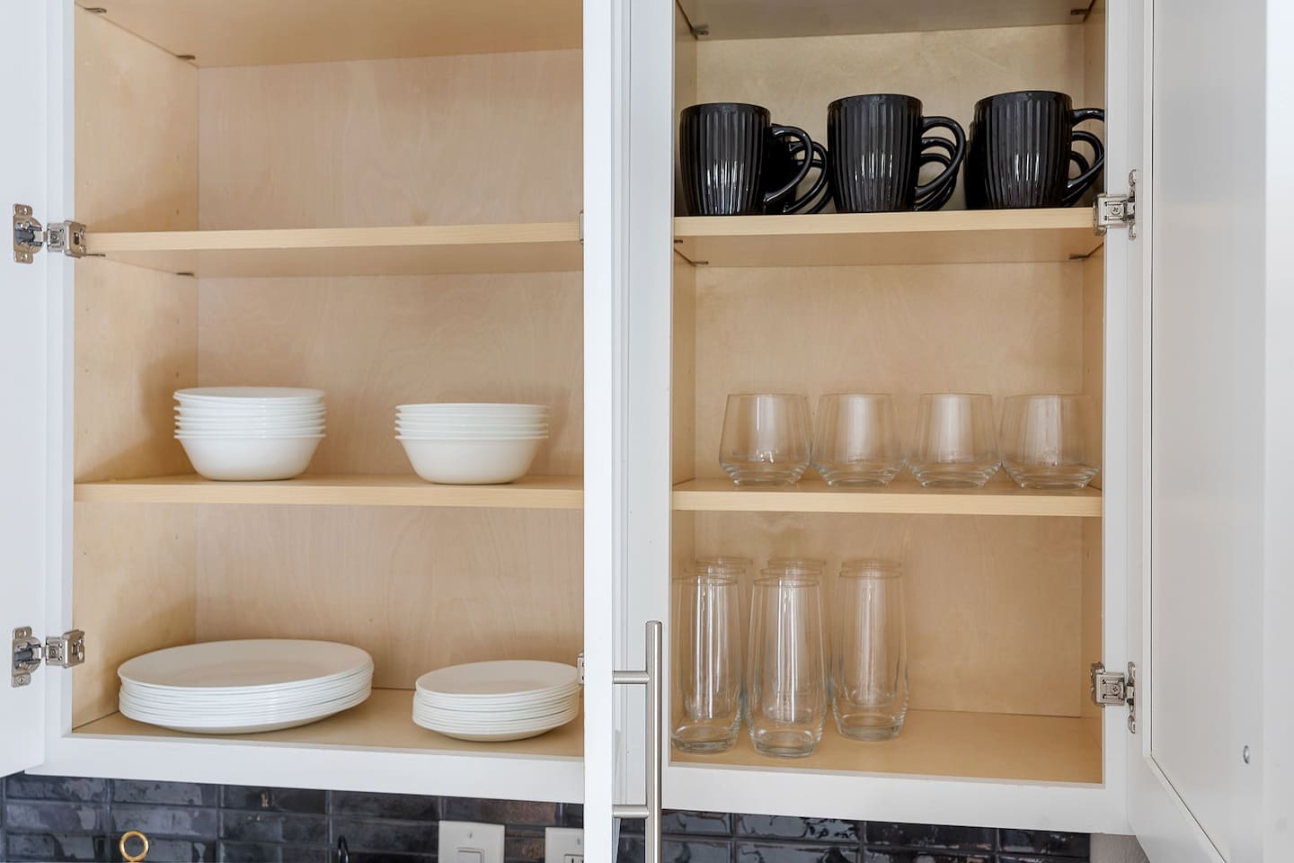 Access all the essentials with neatly organized cabinets stocked with dishes, mugs, and glassware. This setup ensures a convenient and comfortable stay.