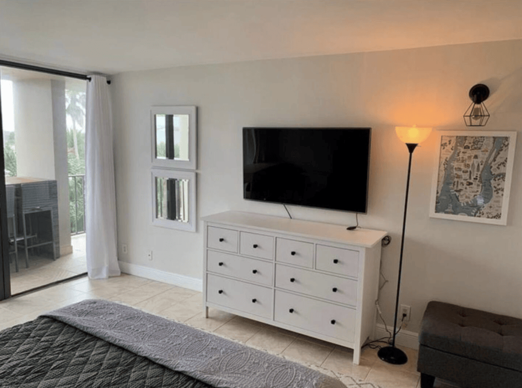 The bedroom also features a TV and workspace.