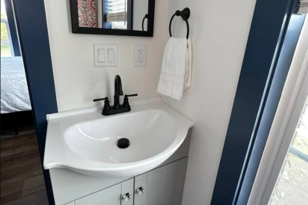 Personal bathroom with sink, toilet and shower.