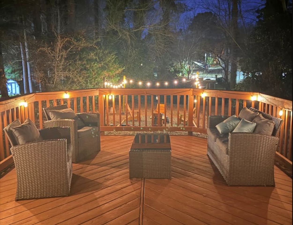 Enjoy peaceful evenings on your private deck with cozy seating, soft string lights, and a wooded view — perfect for relaxing after a day exploring Raleigh.
