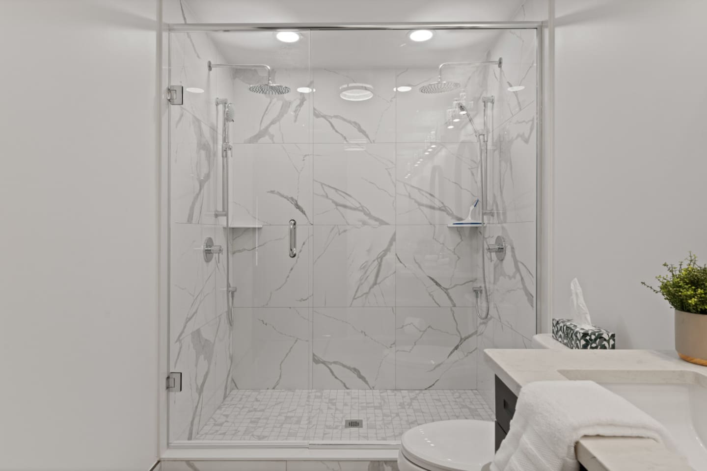 3rd floor ensuite bathroom features a spacious shower with double rain shower heads.