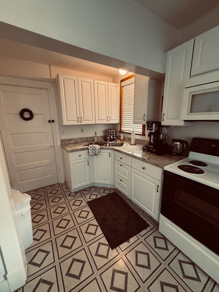 Fully equipped kitchen with stove, microwave, coffee maker, and cookware for easy meals