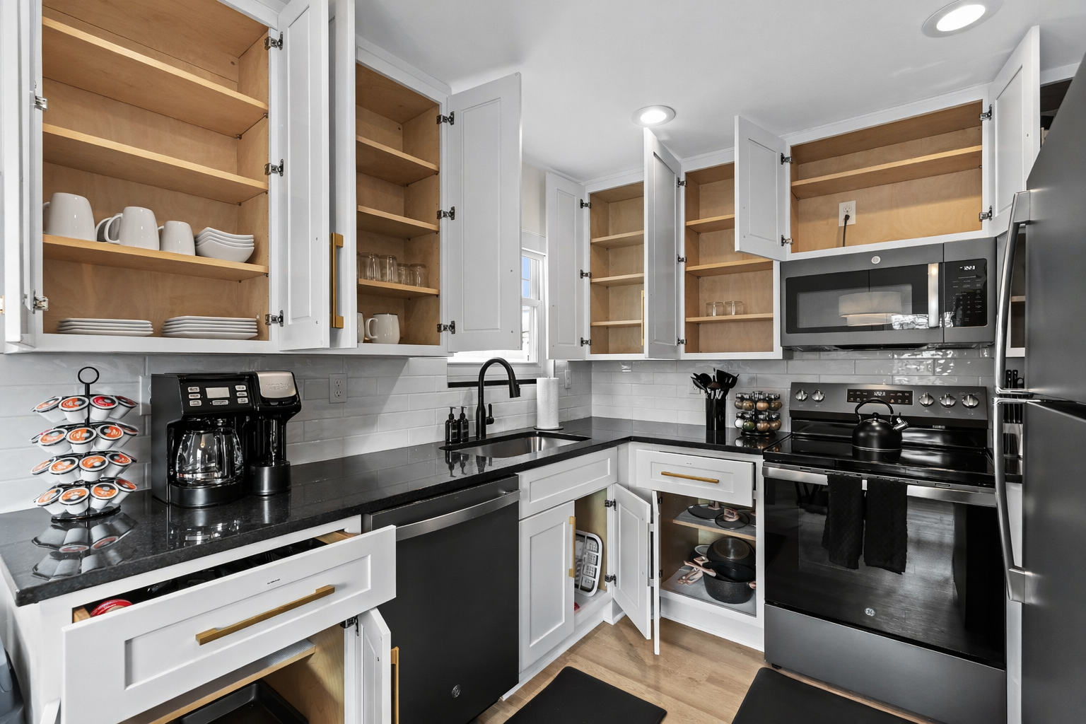 Fully stocked kitchen with ample cabinet space, modern cookware, and thoughtful details—everything you need to cook comfortably and feel right at home.