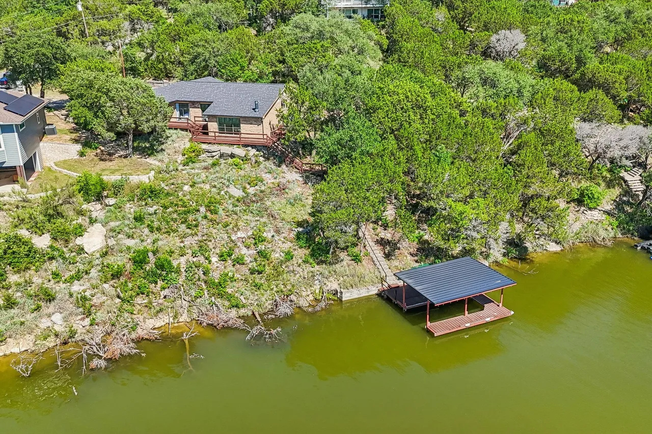 Private lakefront home surrounded by mature trees.