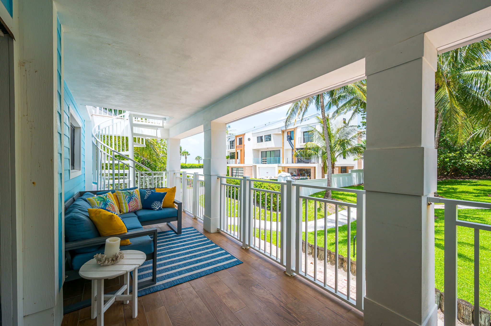 Private balcony surrounded by lush greenery, featuring outdoor dining and seating—perfect for morning coffee, al fresco meals, or evening relaxation.
