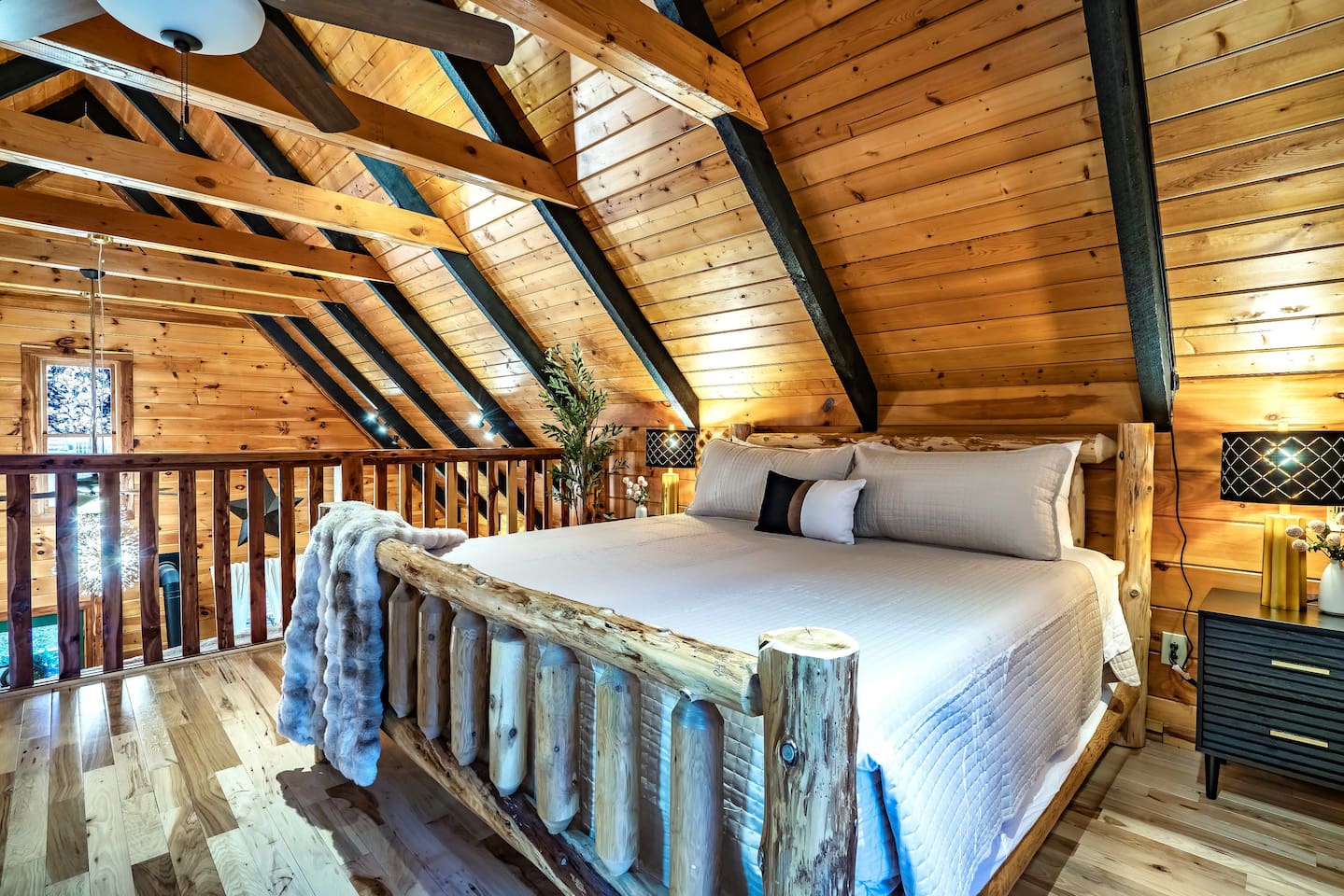 Modern and cozy loft suite featuring a king-size bed in a mountain cabin, designed for restful nights and memorable mountain retreat experiences.