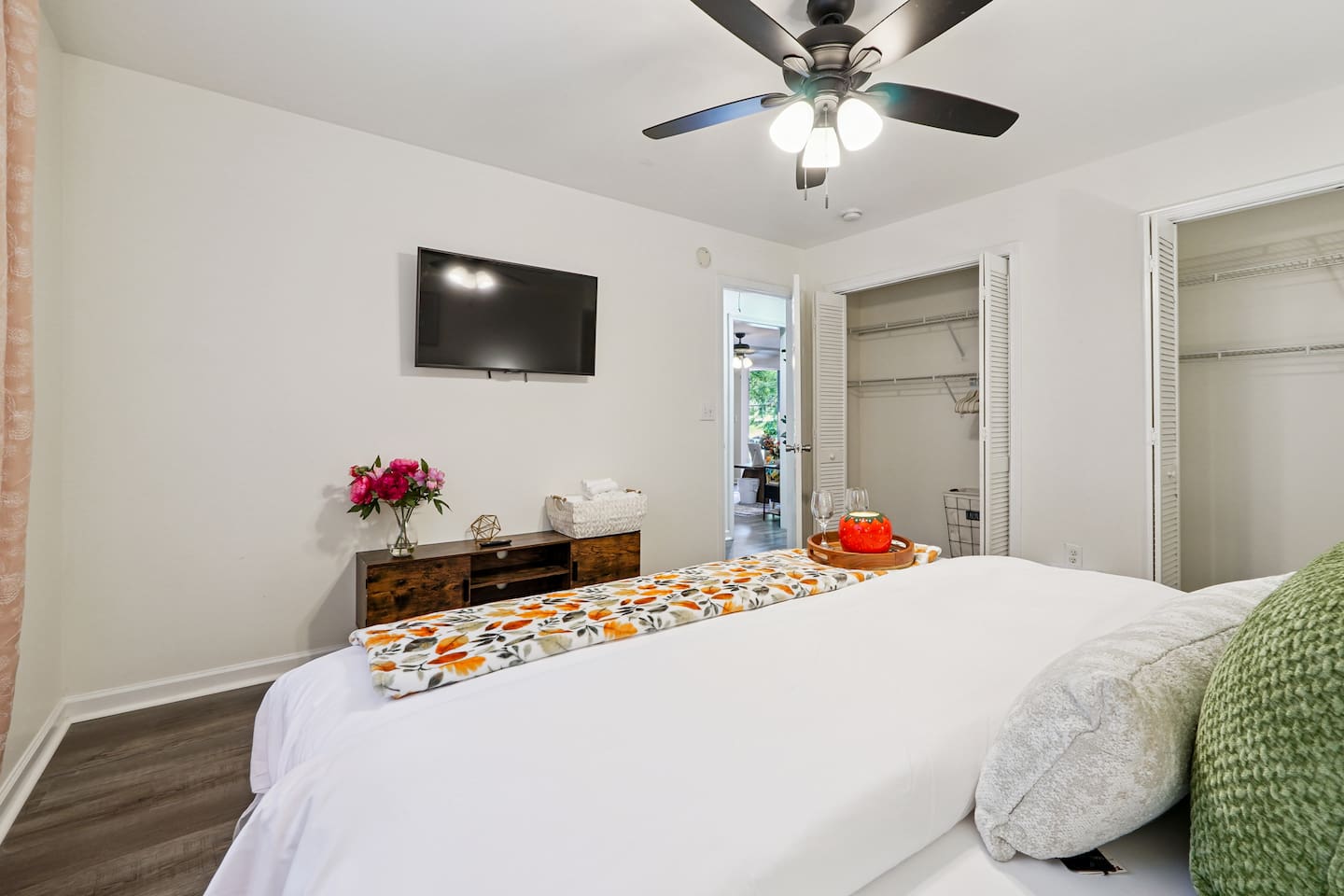Master bedroom featuring a comfortable king bed and an Amazon Fire-powered Smart TV. The shared bathroom is conveniently right next door. This room includes 2 full-body towels, 2 washcloths, and 2 hand towels for your stay.