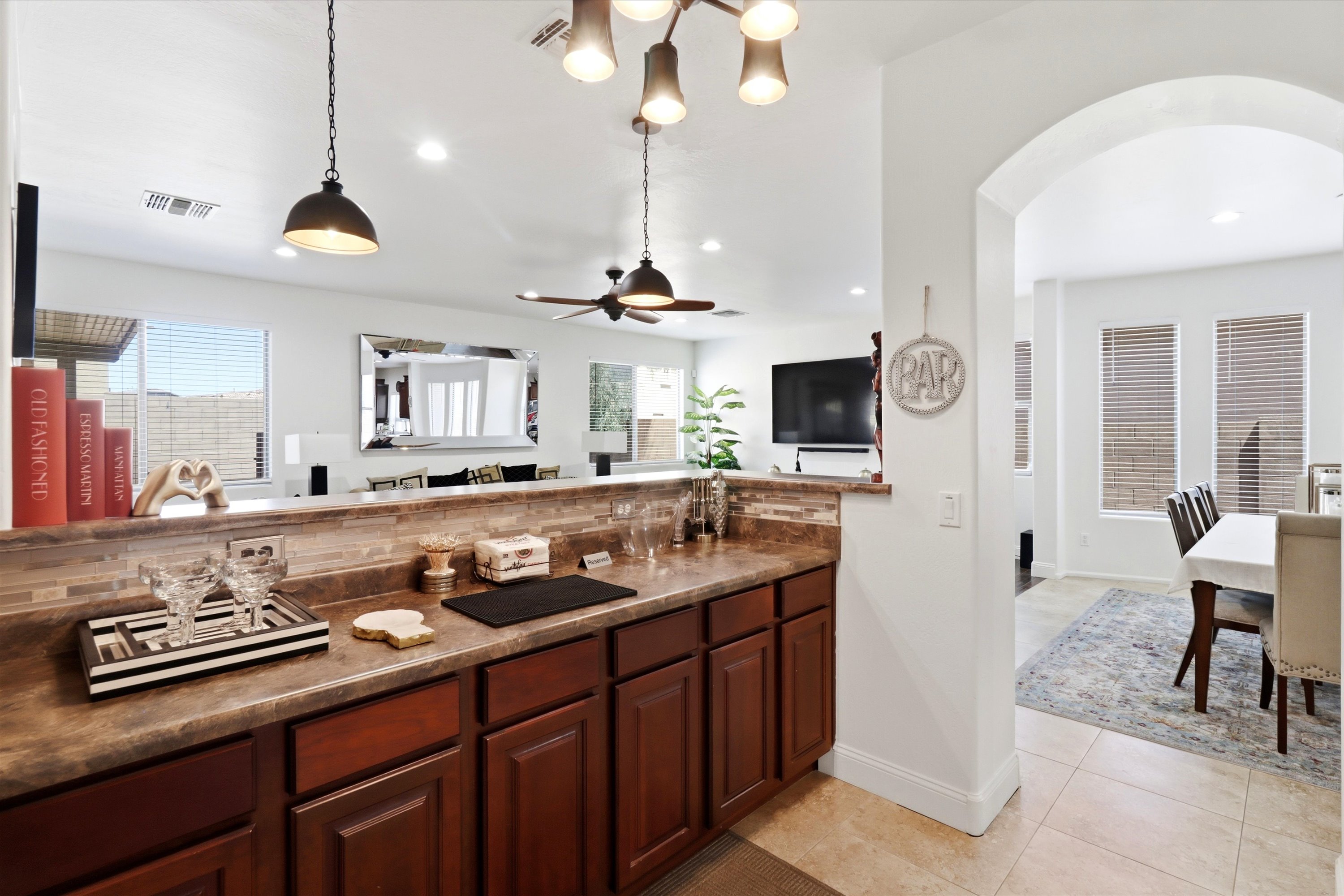 Kitchen bar area with pendant lighting, counter space, and an easy view into the living room and dining area.