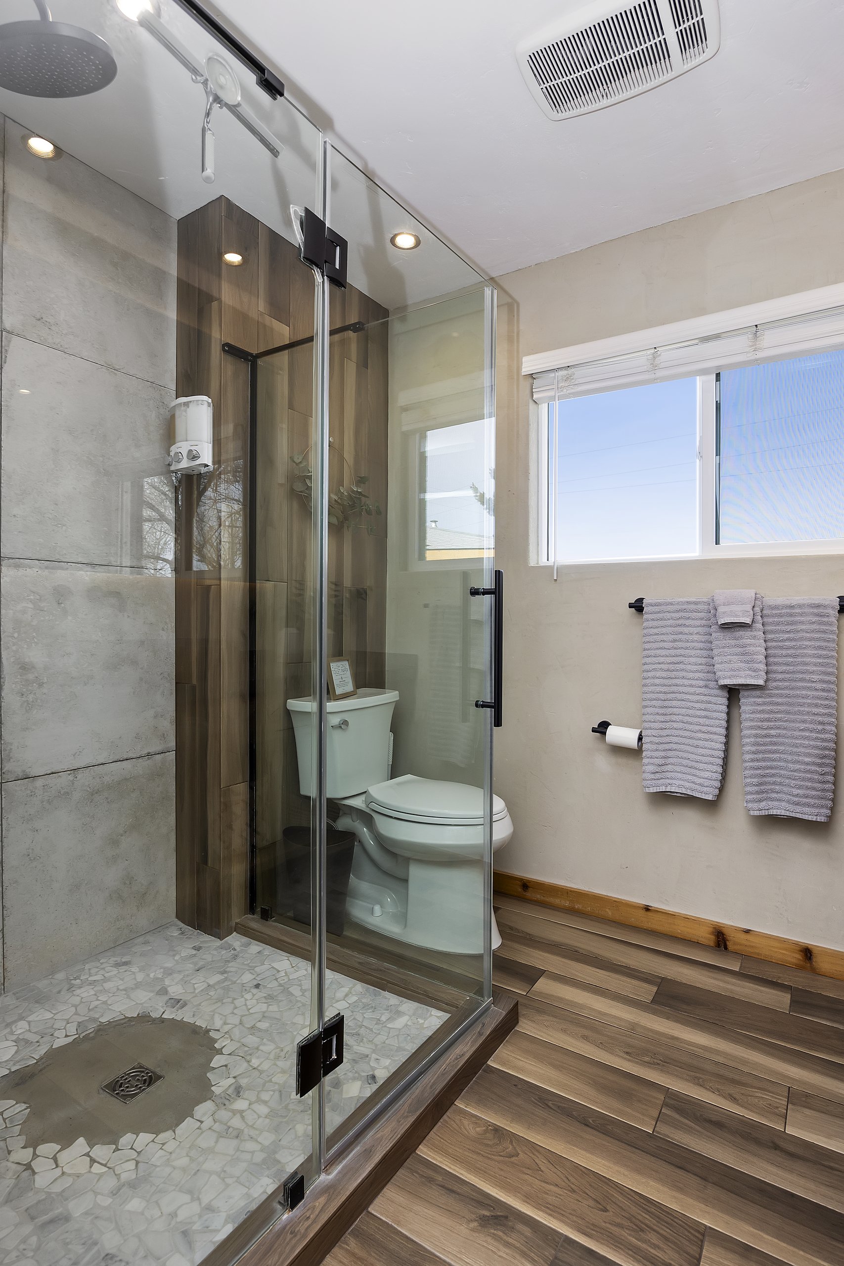 Unit 2 bath — glass and stone walk-in shower, updated and spotless