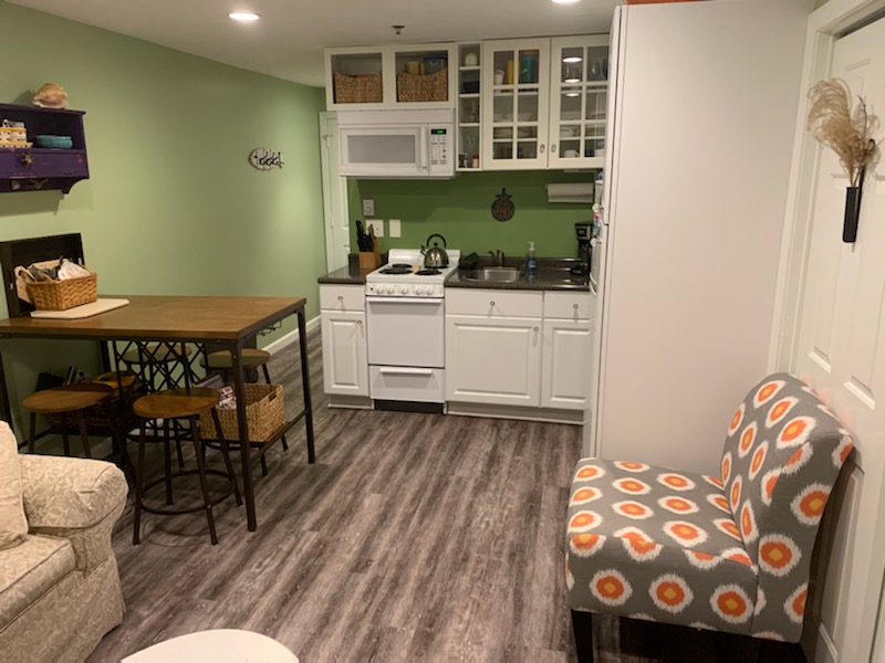 Kitchen area complete with apartment size stove/oven, full size fridge, microwave, and coffee maker.