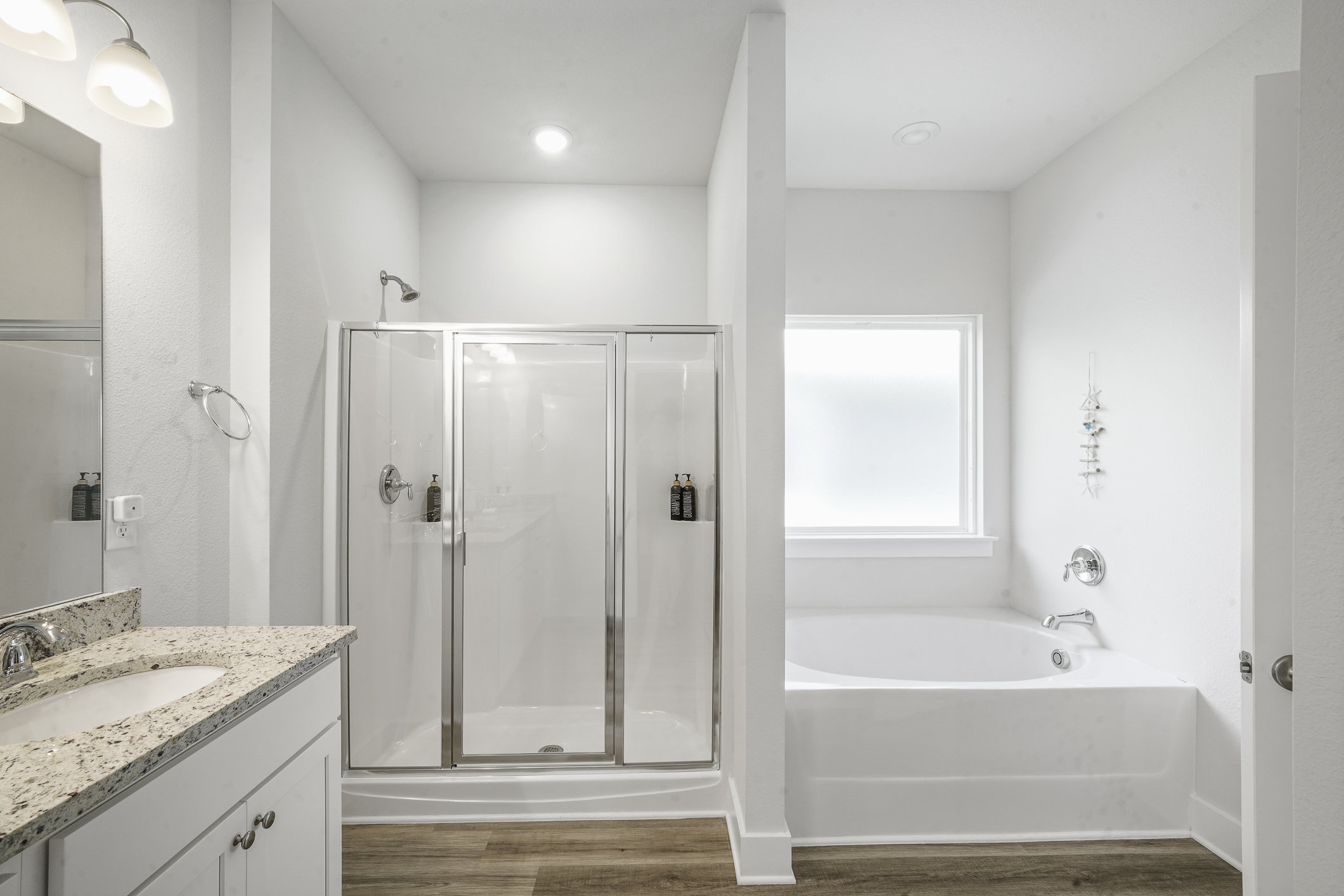 Primary bathroom: Dual sinks, tub and walk-in shower, perfect for busy mornings