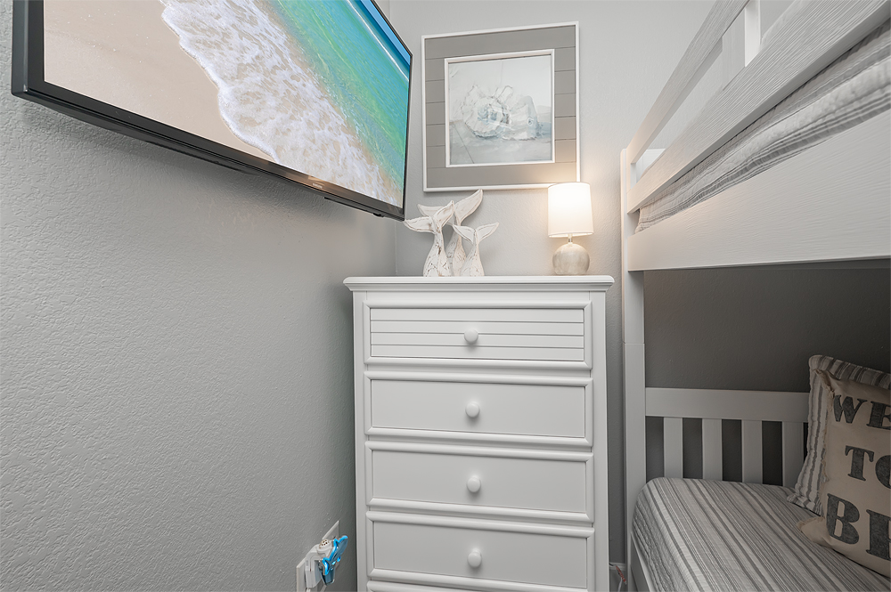 Bunk room with storage and flat screen for the kiddos