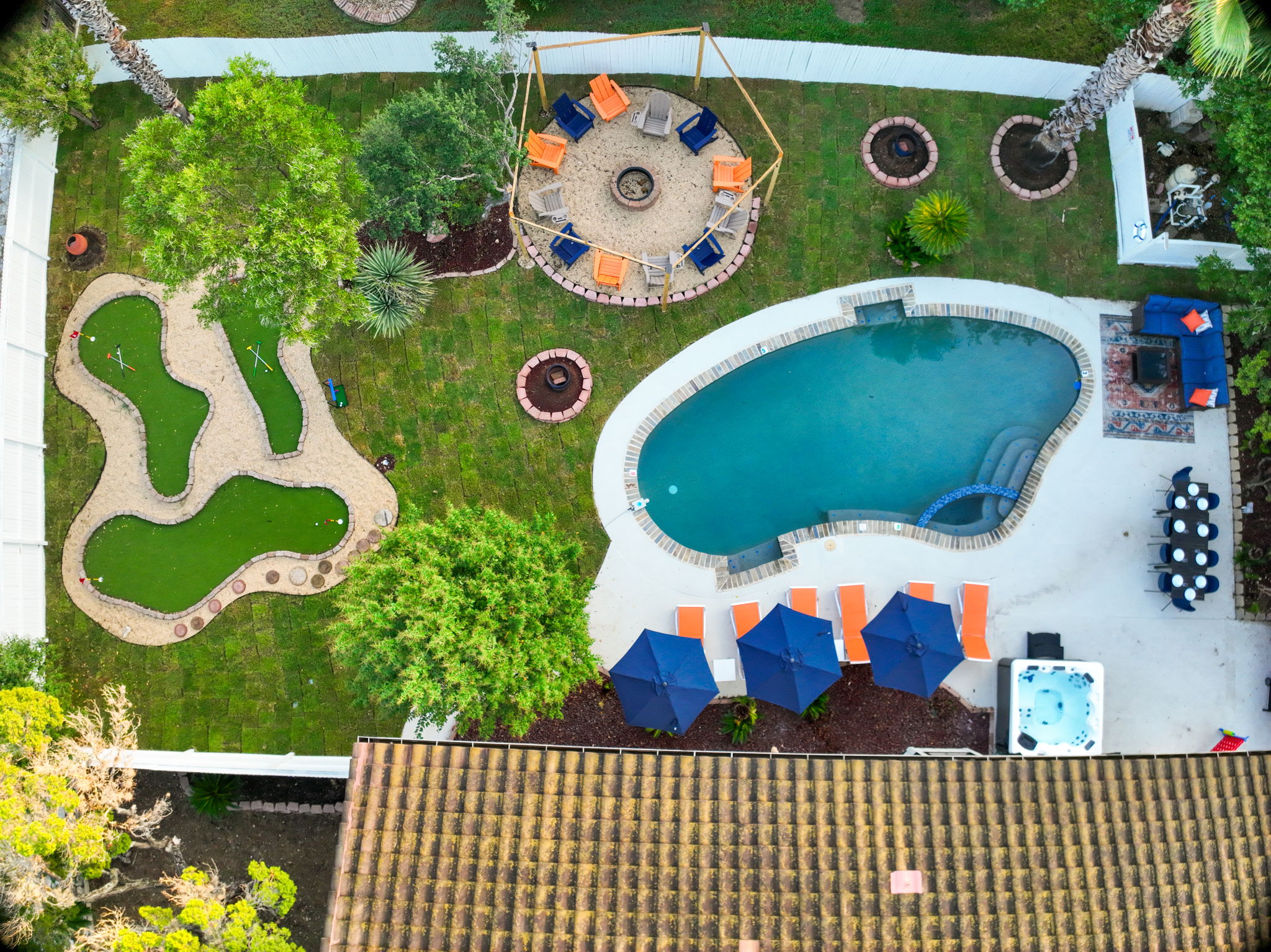 Bird’s-eye view of your private oasis - sparkling pool, mini golf, hot tub, firepit, and multiple spaces to lounge, dine, and enjoy under the Texas sky.