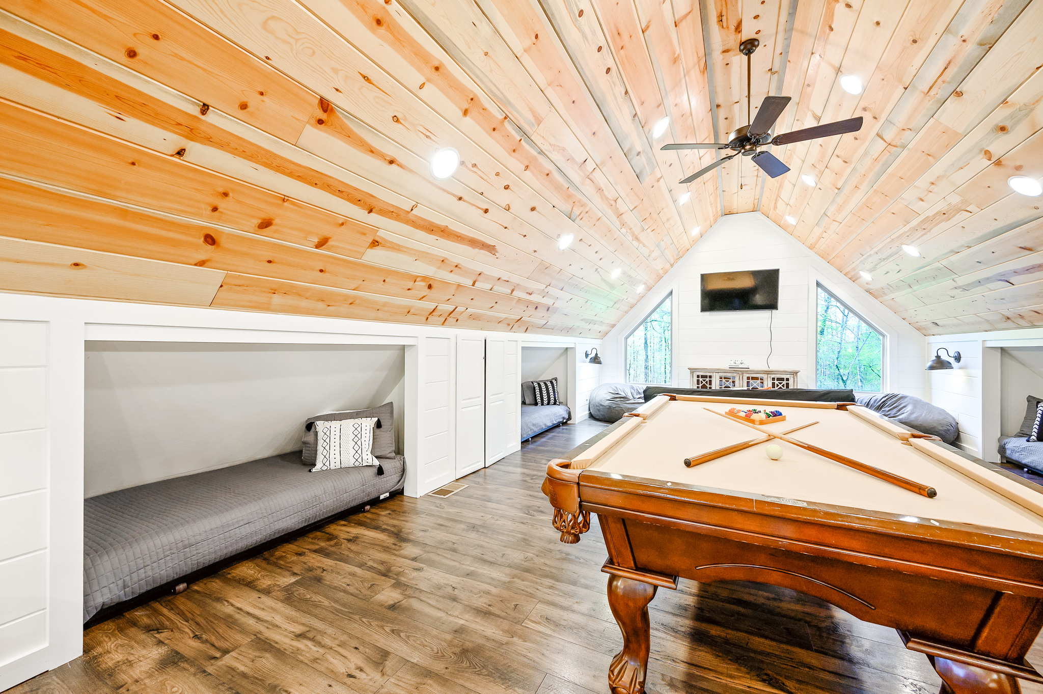 Game loft with pool table, Xbox, smart TV and four twin beds.