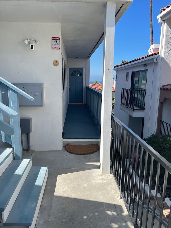 Private entry (with only one stair) with self check-in key pad.  The parking for this unit is down two flights of stairs but people could be dropped off in driveway above to have just one stair to enter this condo.