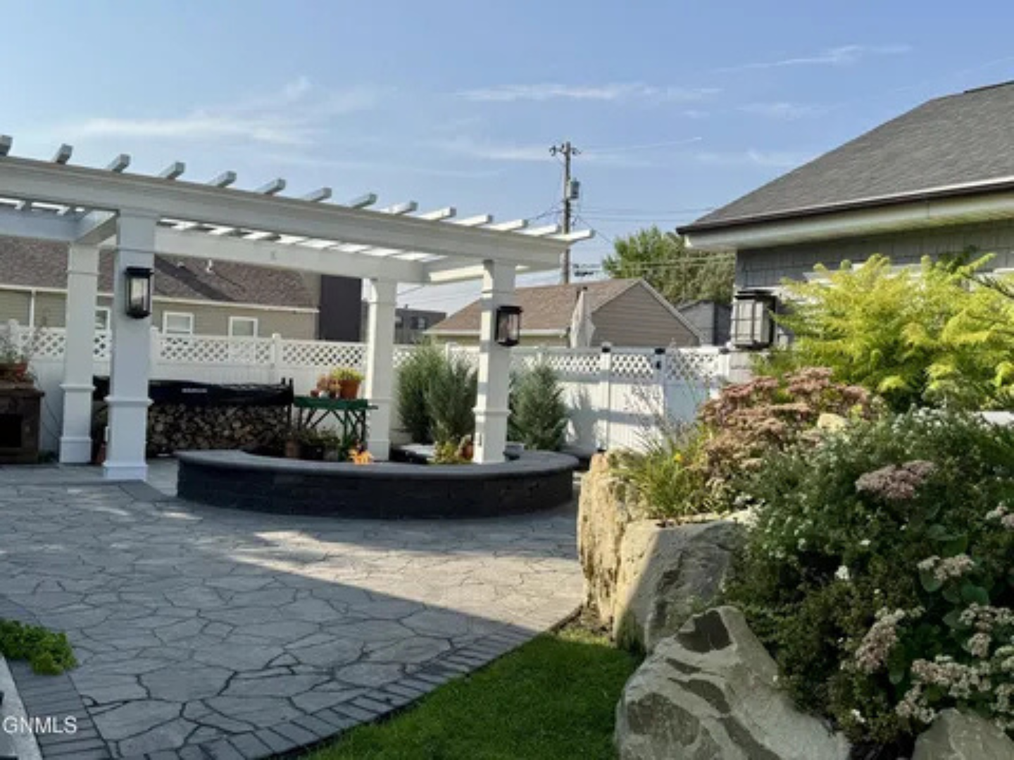 This patio area gives you room to unwind outside with landscaping all around.