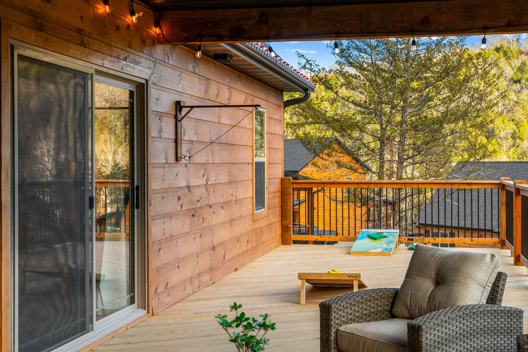 Covered deck with comfortable seating to enjoy the outdoors.