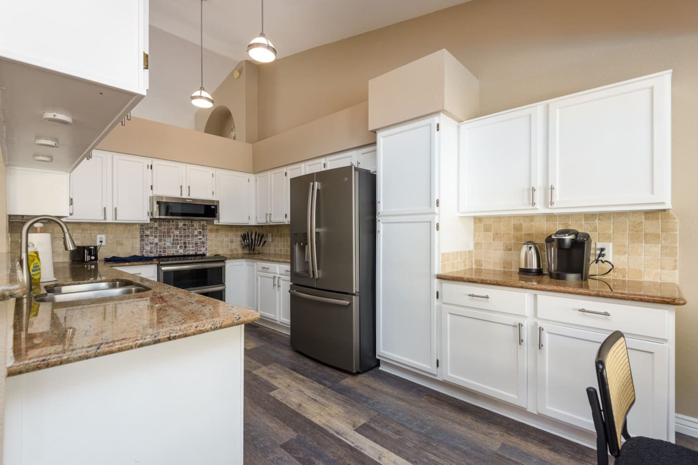 Full kitchen with stainless steel appliances, granite counters, coffee station, and plenty of cabinet storage for everyday meals.