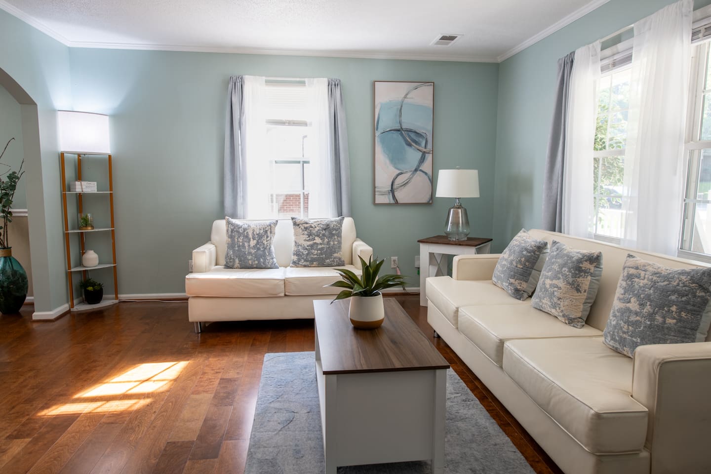 Spacious and sunlit, this cozy living room offers the perfect spot to read, reconnect, or relax in peace.