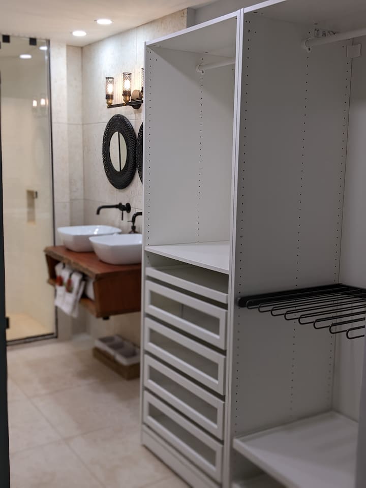 This is the primary Bathrooms View from the bedroom. We have Dual open closet systems with plenty of space for you to spread your 15 bathing suits you bring;) 