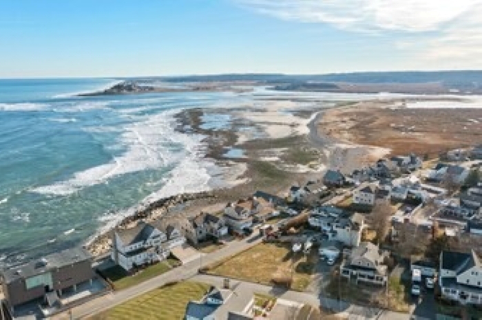 Bird’s-eye view of the house, backyard, and beautiful coastal setting.
