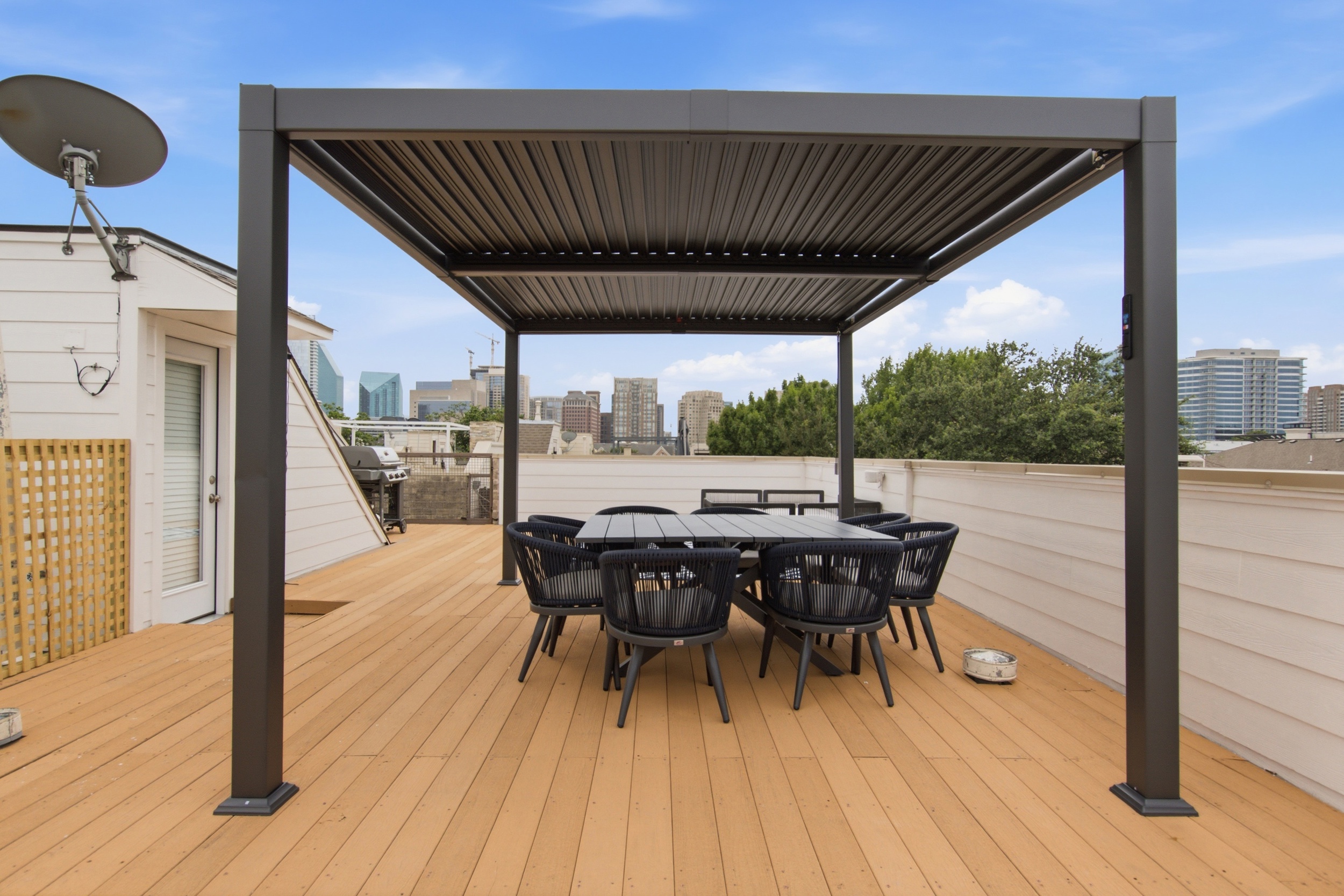 Dine al fresco with stunning skyline views under a stylish pergola!