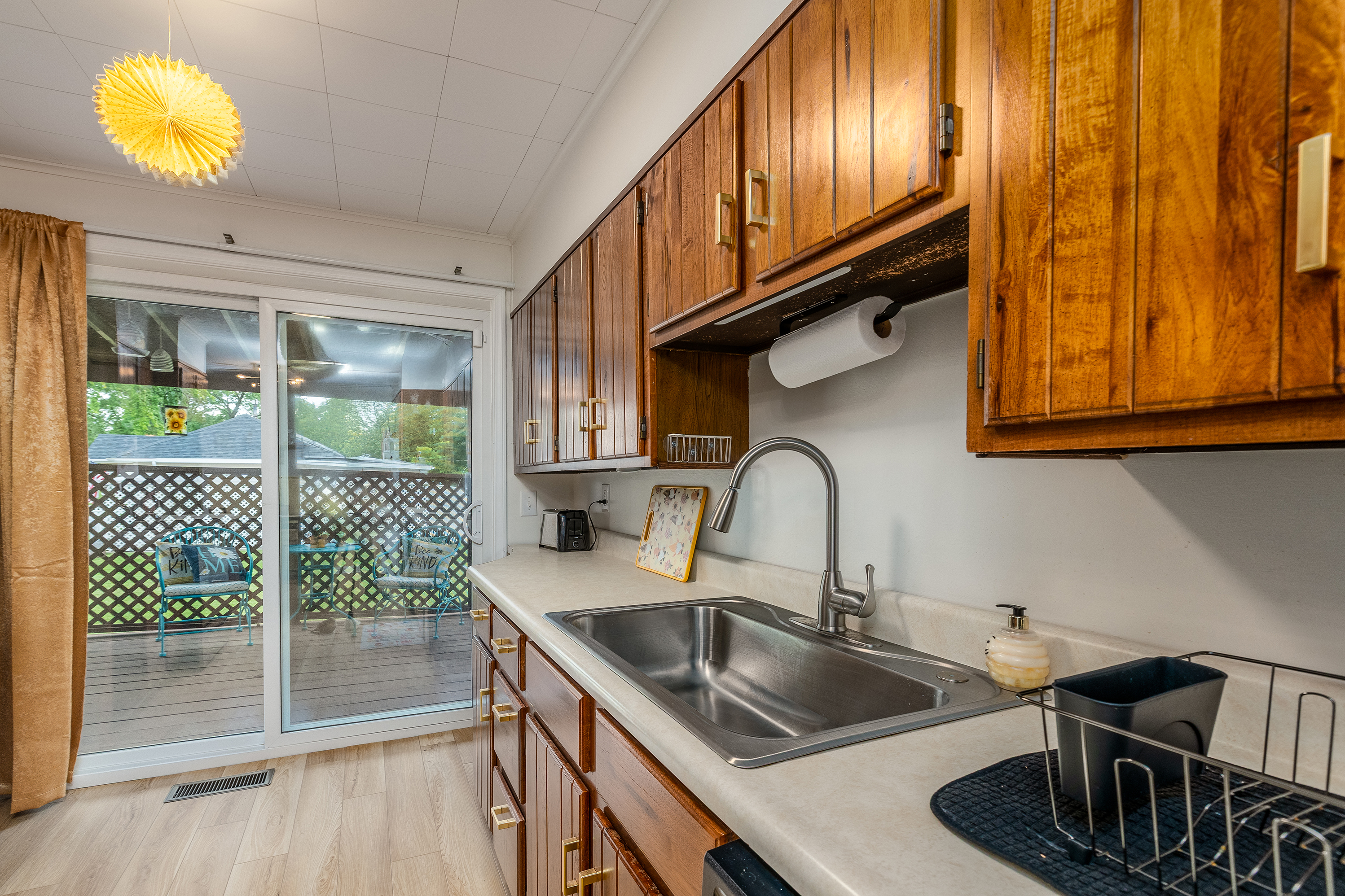 Sunshine & suds! Wash up at the kitchen sink with a view, load the dishwasher with ease, then step through the sliding door to the covered deck and let the breeze in.