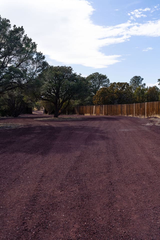 Follow this charming rustic driveway lined with juniper trees and endless sky, leading you to a cozy retreat tucked away in nature. Breathe in the fresh air, soak in the serenity, and let the adventure begin!