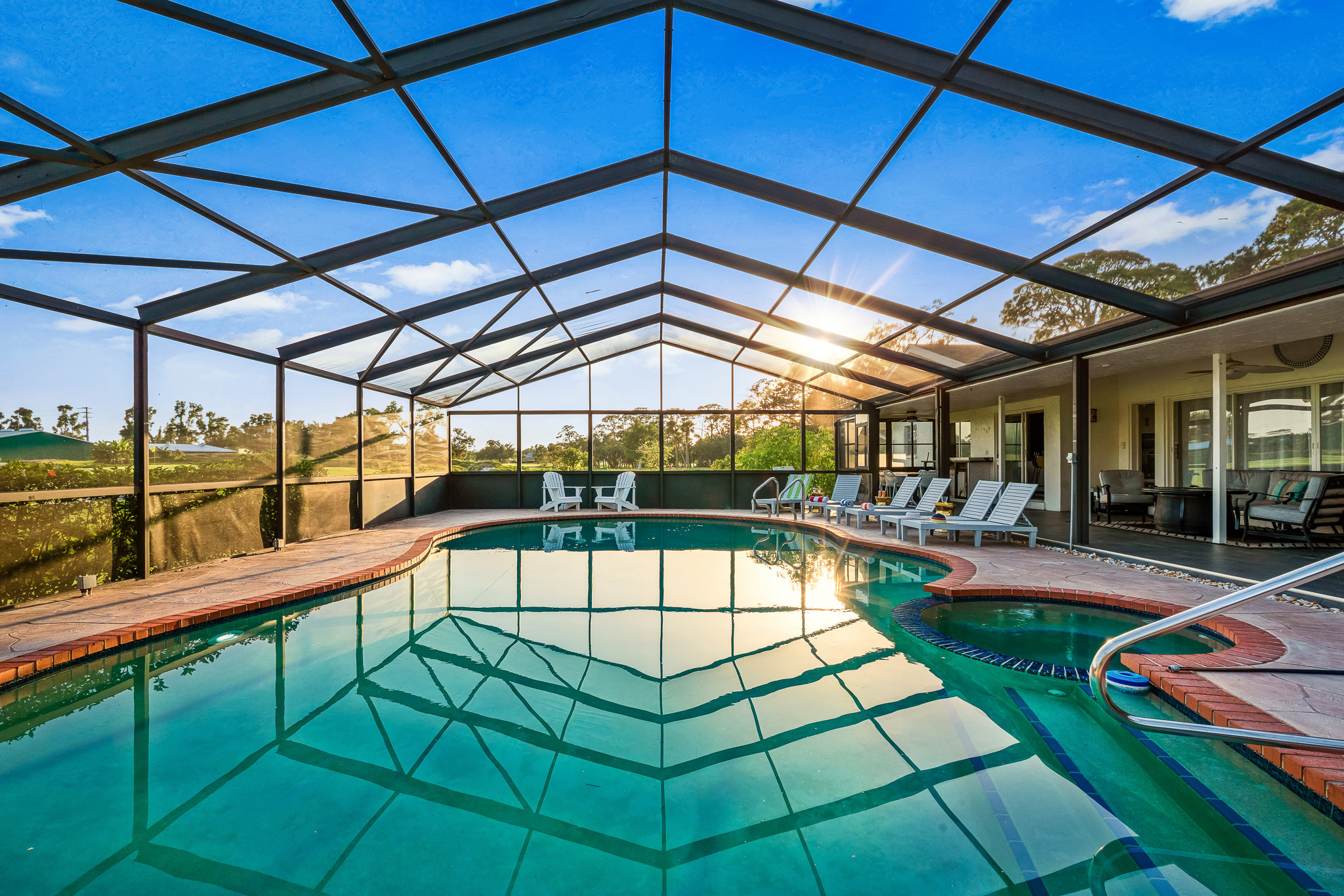 Relax under the screened-in lanai with a sparkling pool, spa, and serene views—your private Florida retreat awaits!