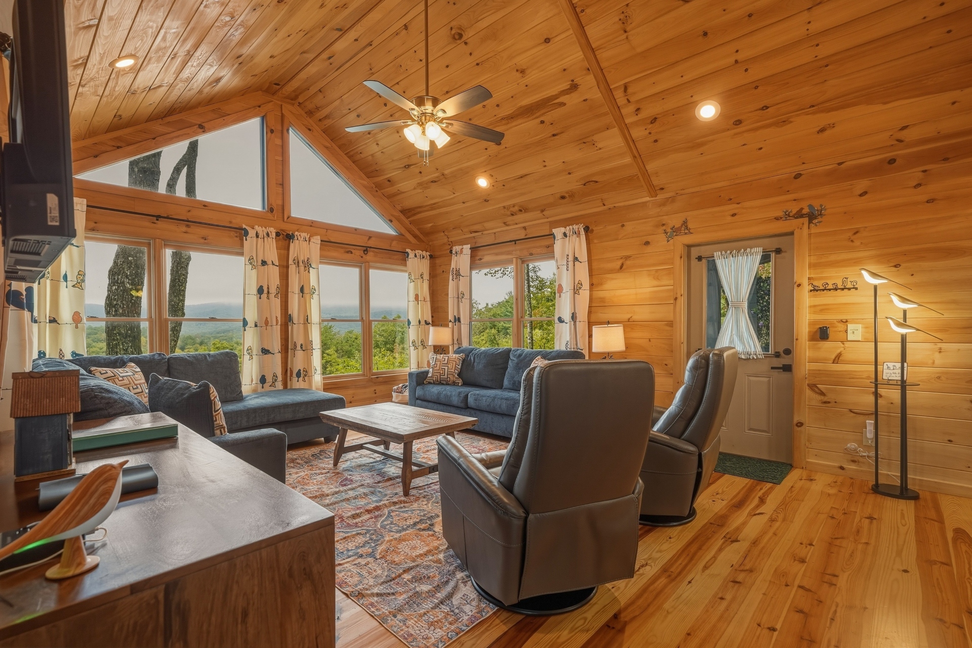 Living area with lots of seating, fire place and smart TV