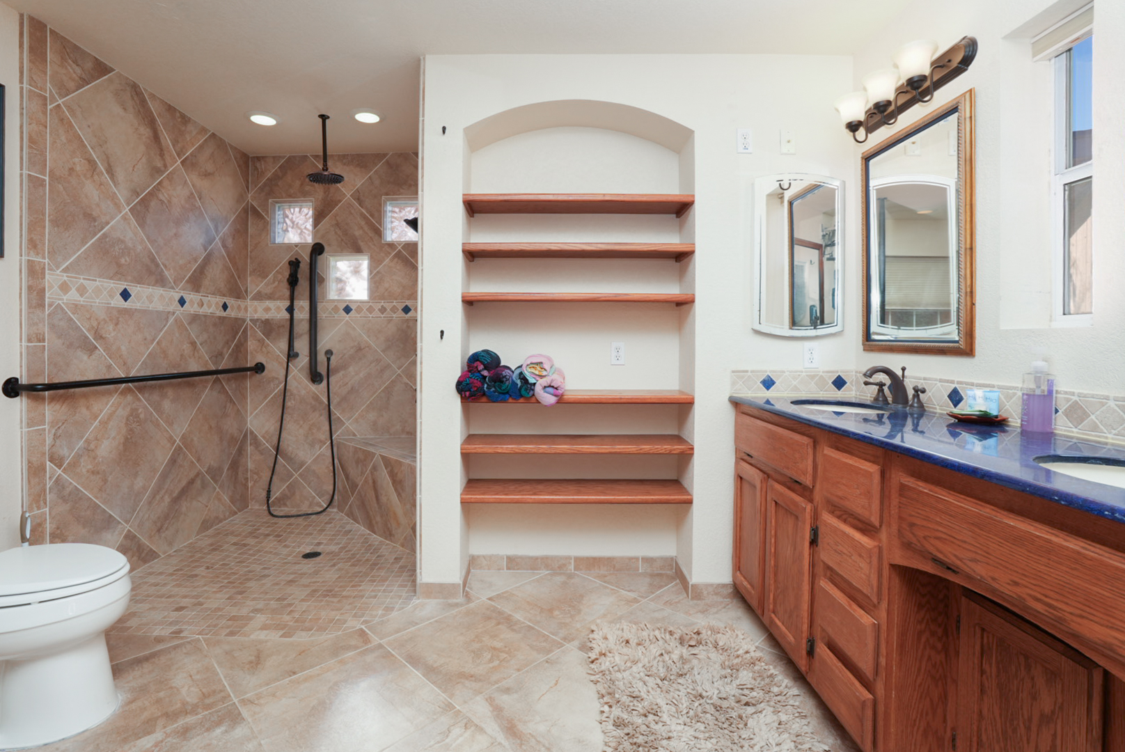 Beautifully designed wheelchair-accessible shower with grab bars and seating—comfort, accessibility, and style all in one.
