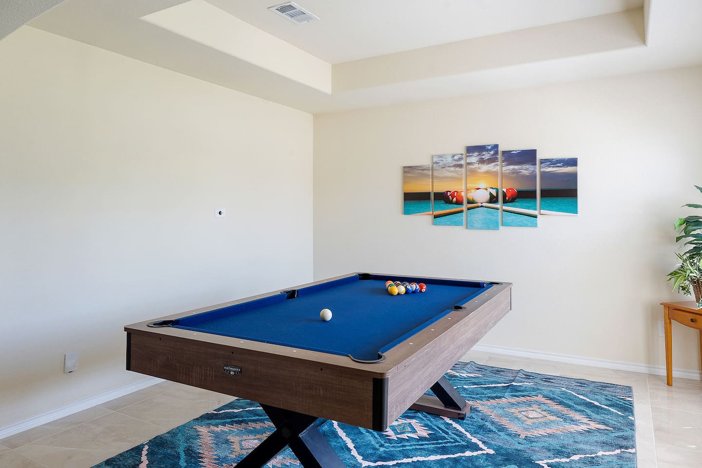 Enter the gaming area with its brightly colored wall painting and immaculate pool table.