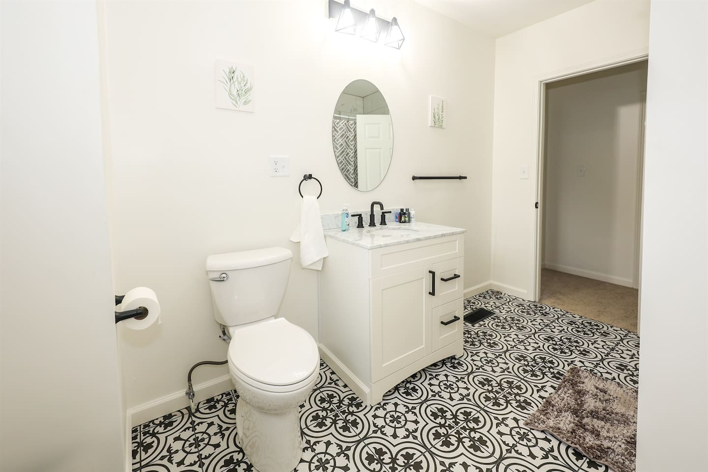 Enjoy a refreshing bath in this full bathroom with a sleek shower tub, designed with minimalist elegance for a calm and spacious feel.

